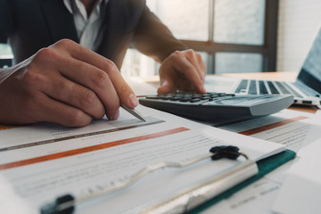 double exposure business man pointing his ideas Data and writing business plan at workplace,man holding pens and making notes trading graph of stock market and using calculator