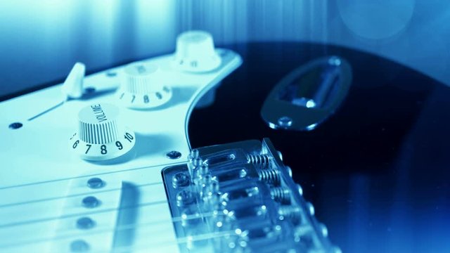 Electric guitar strings close up in effect blue design background. 4K UHD video.