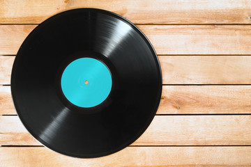 Record plate on wooden background