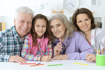 Big family with cute little girl doing homework