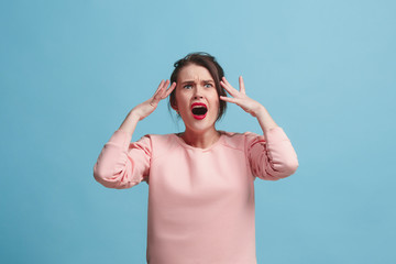 Fototapeta premium Beautiful woman in stress isolated on blue