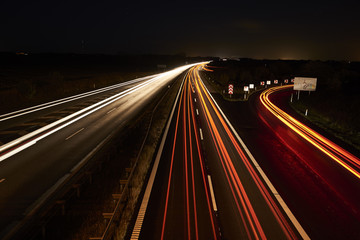 Fototapeta na wymiar highway by night and with cars and traffic in motion