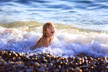 the little girl swims in the sea