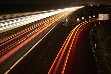 highway by night and with cars and traffic in motion