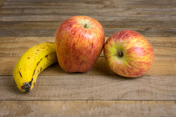 apples and banana on wooden table