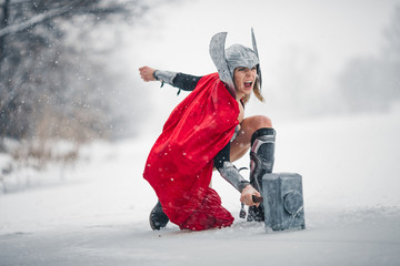 Furious woman in image of Germanic-Scandinavian God of thunder and storm. Cosplay. - obrazy, fototapety, plakaty
