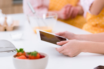 cropped shot of woman using table while cooking