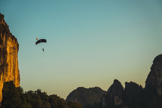 Paraglider flying in mountains