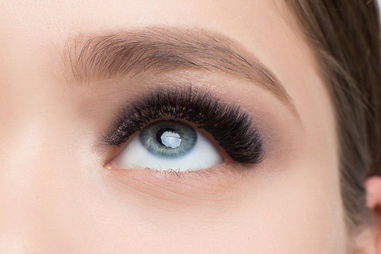 Closeup image of beautiful woman eye with fashion makeup and long eyelashes