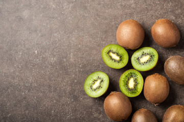 Fresh kiwi fruits on stone table