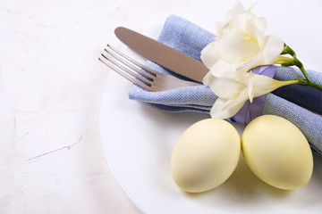 Easter laying table appointments, table setting options. Silverware, tableware items with festive decoration. Fork, knife and flowers. Happy easter holiday.