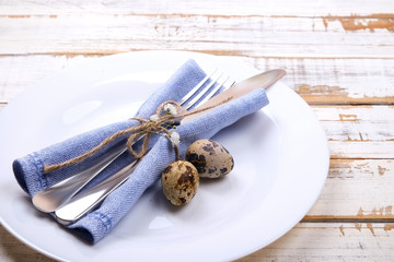 Easter laying table appointments, table setting options. Silverware, tableware items with festive decoration. Fork, knife and flowers. Happy easter holiday.