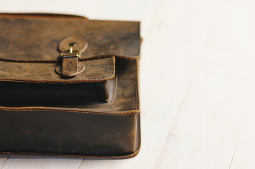 Bag briefcase for businessman men, leather brown bag on a wooden background. Men's fashion,...