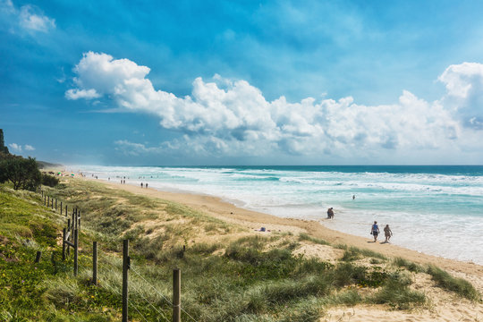 COOLUM, AUSTRALIA, FEB 18 2018: People enjoying summer at Coolum main beach - a famous tourist destination in Queensland