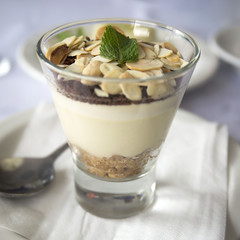 Banana mousse with peanut chips in a glass. Delicious dessert. 