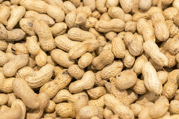 Many peanuts in shells, one upon the other. background