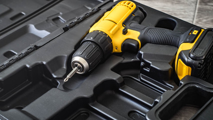 hand electric tool: a yellow screwdriver in a molded black box