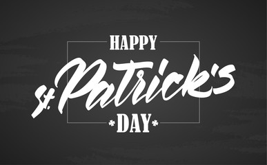 Hand drawn calligraphic brush type lettering of Happy St. Patrick's Day with frame on chalkboard background