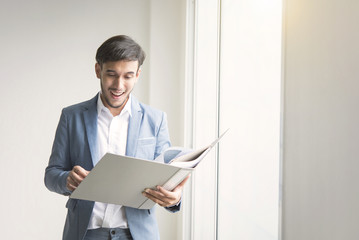 Young businessman open folder work at the office.