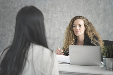 Young woman applicant and human resources his conversation recruitment procedure in corporation.
