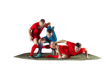 Fototapeta na wymiar Football players tackling for the ball over white background