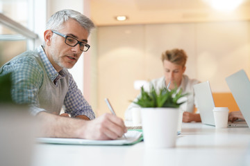 Teacher meeting around table with students