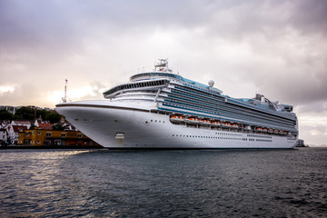 Large white luxury cruise ship in a harbour