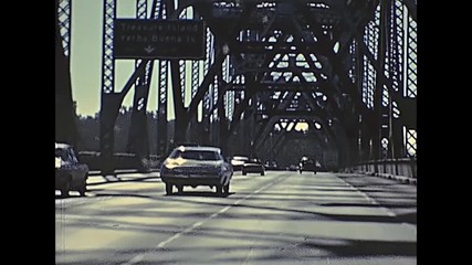 POV of vintage car crossing Oakland Bay Bridge passing by Treasure Island to Oakland. Archival footage in eighties. San Francisco, California, United States in 1980.