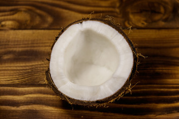 Fresh ripe coconut on rustic wooden table