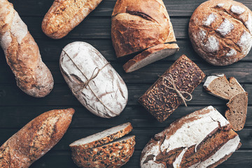 Delicious fresh bread on wooden background