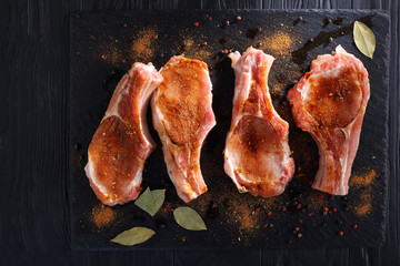raw pork chops seasoned with spices