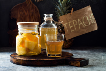 Fermented mexican pineapple Tepache. Homemade raw kombucha tea with pineapple. Healthy natural probiotic flavored drink. Copy space