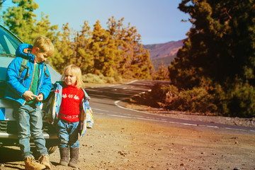 little boy and girl travel by car on the road
