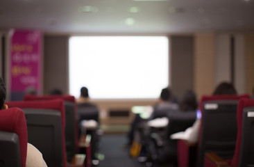Blank White Screen in Presentation Room. Blurred. Bokeh
