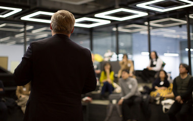 Business Professional Person Presenting to a Group of People. Discussion.