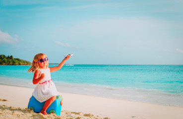 cute little girl travel on summer beach