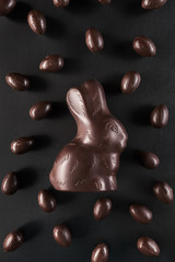 Chocolate Easter bunny and eggs on dark background