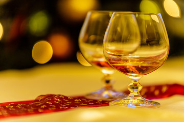 Brandy in two glasses on celebrate table.close up, Christmas background