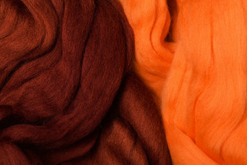 Bright colored merino wool for felting and needlework, hobby. The stripes of burgundy color and...