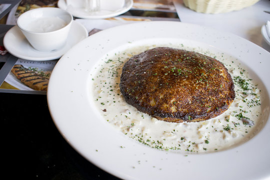 Hot dranik on a white plate in a mushroom sauce.