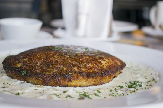 Belarusian dranik on a white plate on the table.