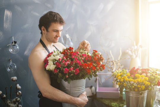 image of florist hugging bounch of flowers in basket.expensive bouquet