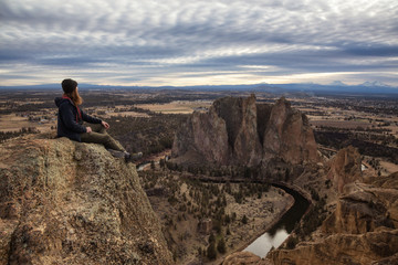 Man enjoying the Beautiful American Mountain Landscape during a vibrant winter day. Taken in Smith Rock, Redmond, Oregon, America. Concept: Adventure, Holiday and Travel