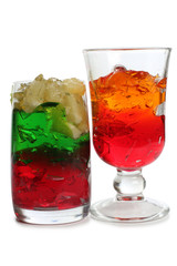 Alcoholic cocktails and fruit in glass glasses on a white background