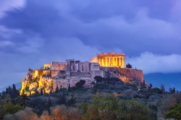 Rolgordijnen Aerial view of the Acropolis Hill, crowned with Parthenon during evening blue hour in Athens, Greece © Kavalenkava