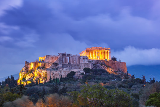 Aerial view of the Acropolis Hill, crowned with Parthenon during evening blue hour in Athens, Greece