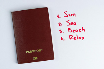  clean red passport and list of vacation plans.