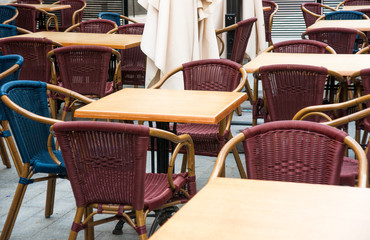 Tables and chairs for cafe in street in summer
