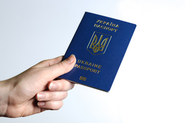 Blue Ukrainian passport in the a woman hands . Isolate