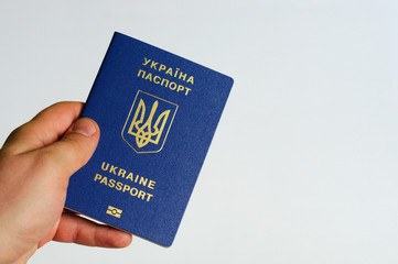 Blue Ukrainian passport in the hands of a man. Isolate